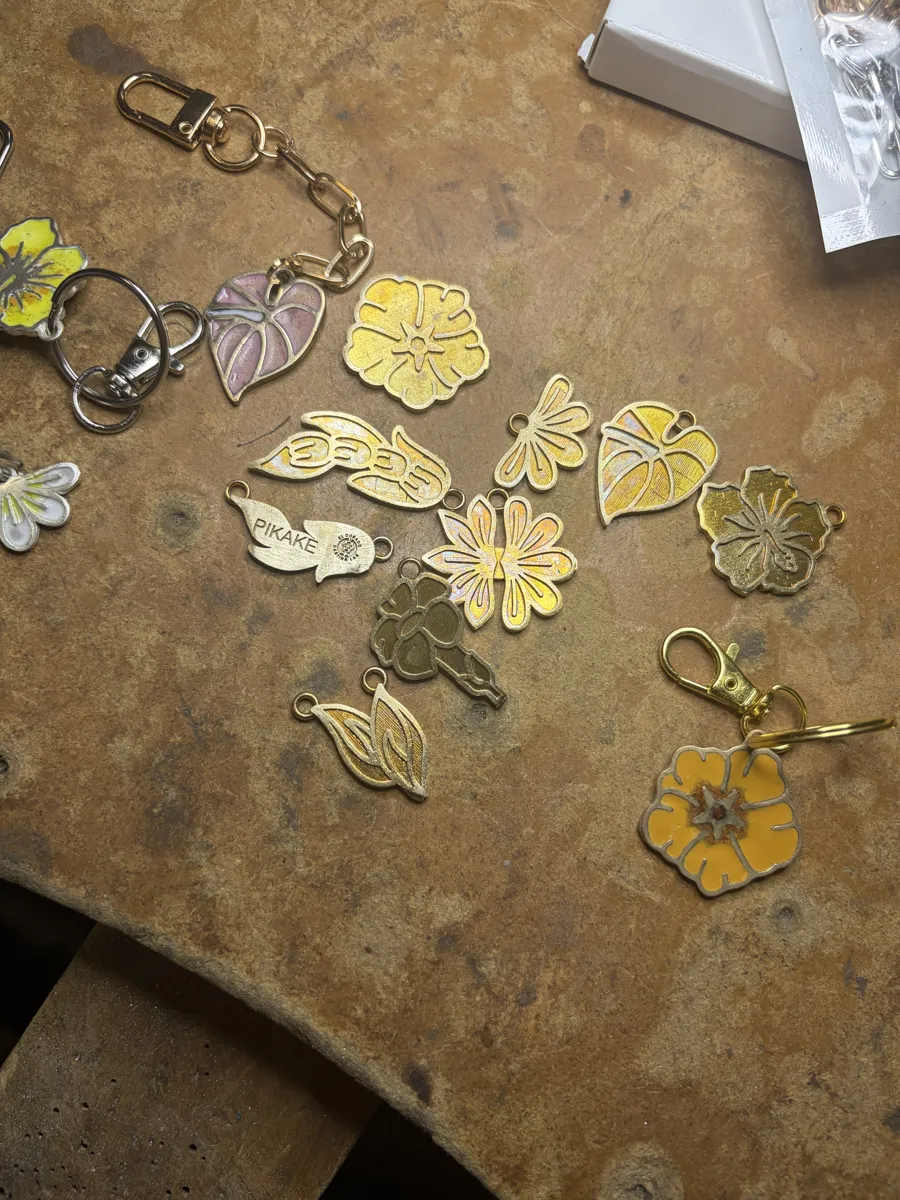 Cast metal flower blanks, some enameled