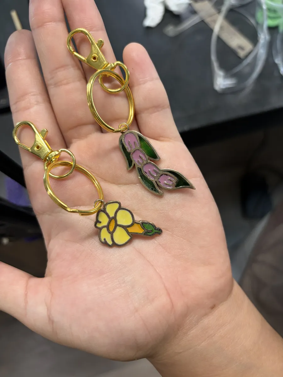 Two finished enamel flower keychains