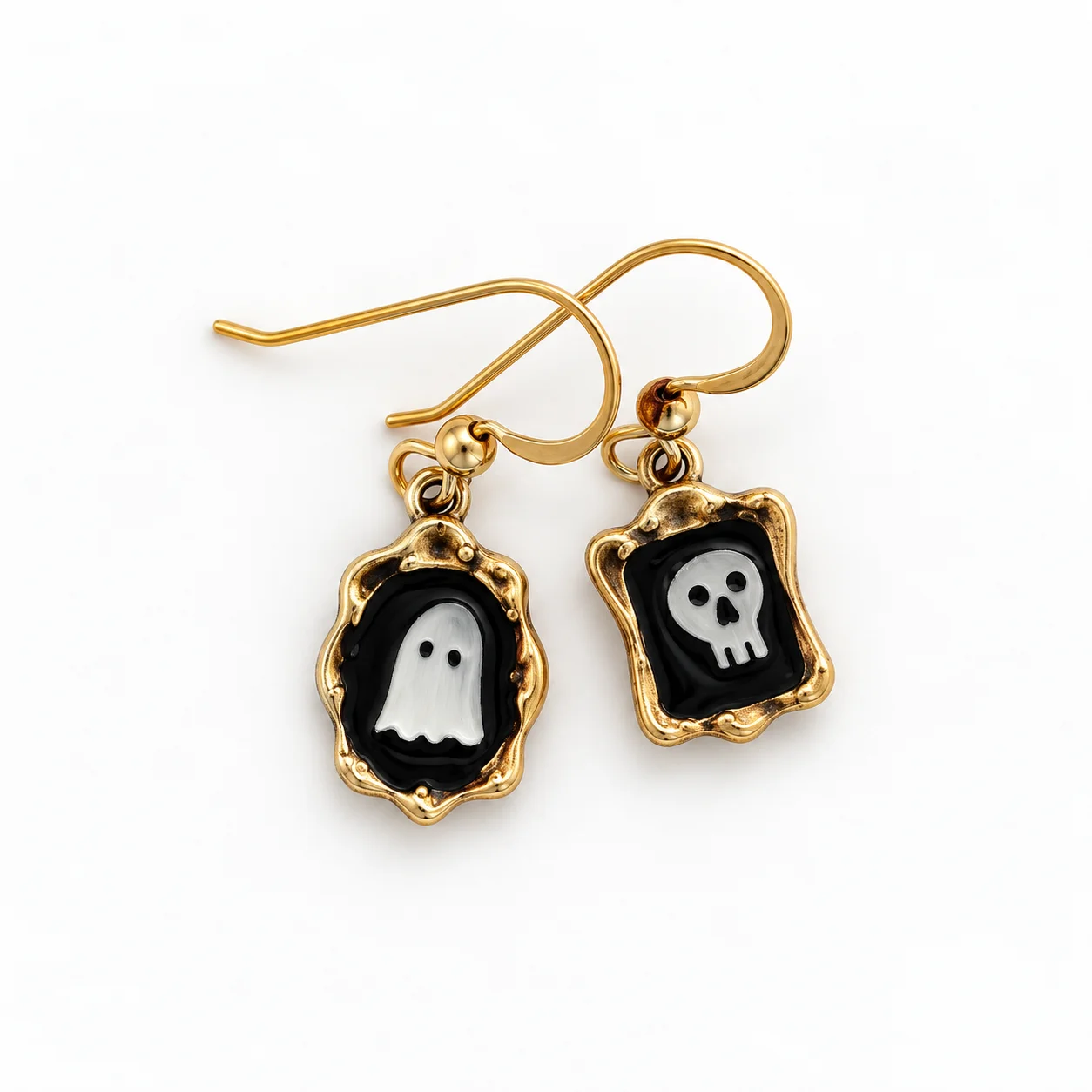 Gold earrings with a white ghost and a white skull on black enamel