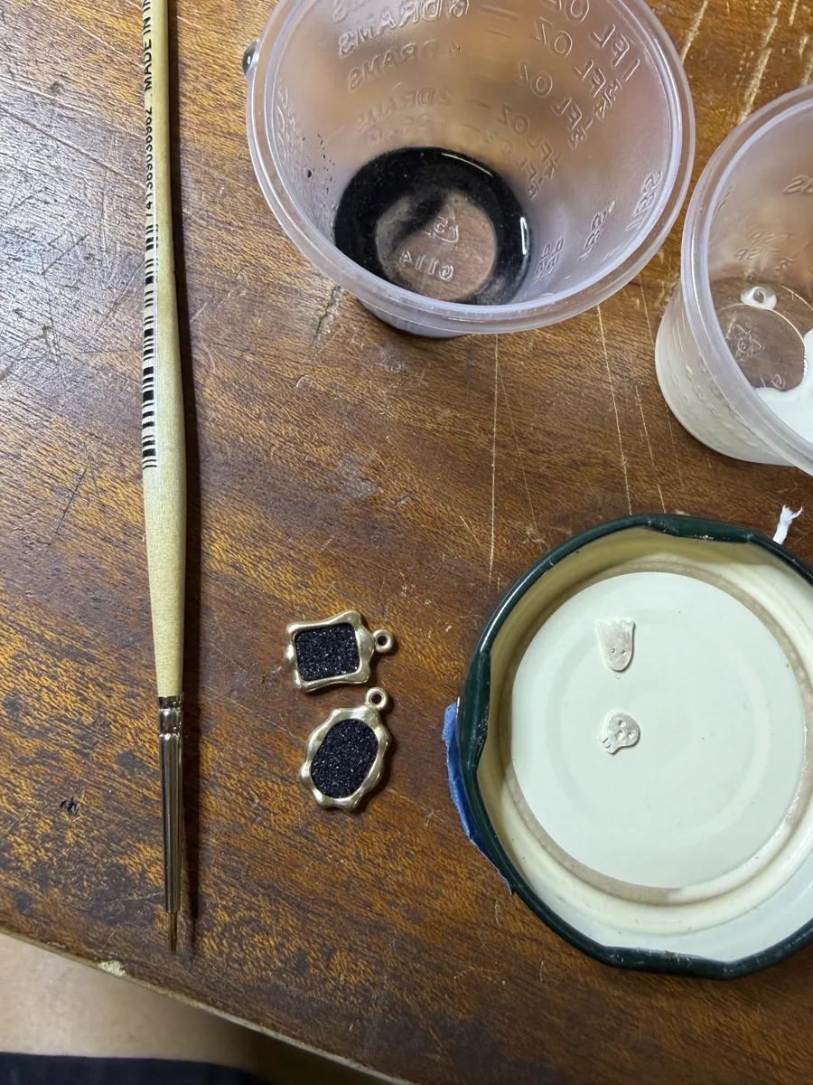 Frames packed with black glass enamel powder